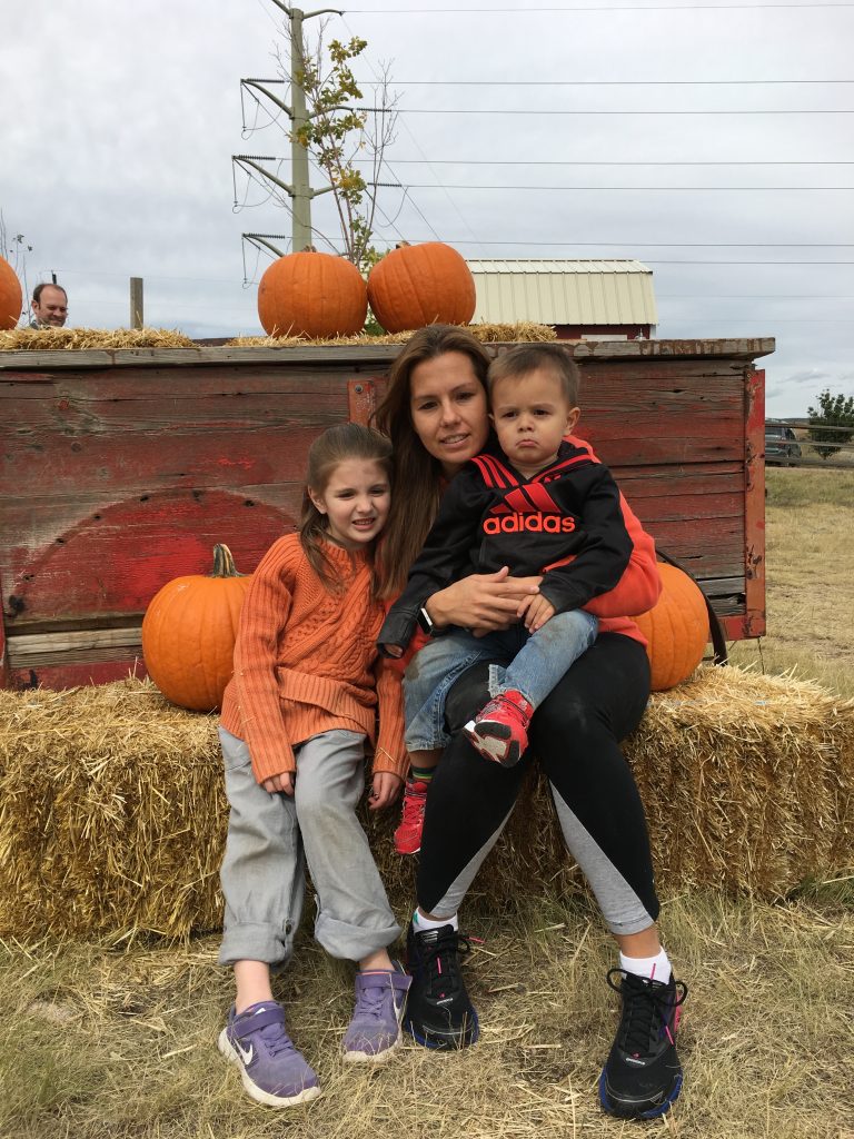 Family picking pumpkins at Noland's Dusty Boots Pumpkin Patch in Edwards, Missouri